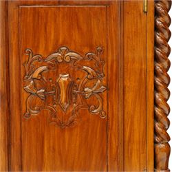 Victorian design rosewood side cabinet, the rectangular moulded top above four frieze drawers with turned wooden knob handles, over twin cupboard doors carved with foliate panels, flanked by barley twist uprights, upon turned bun feet