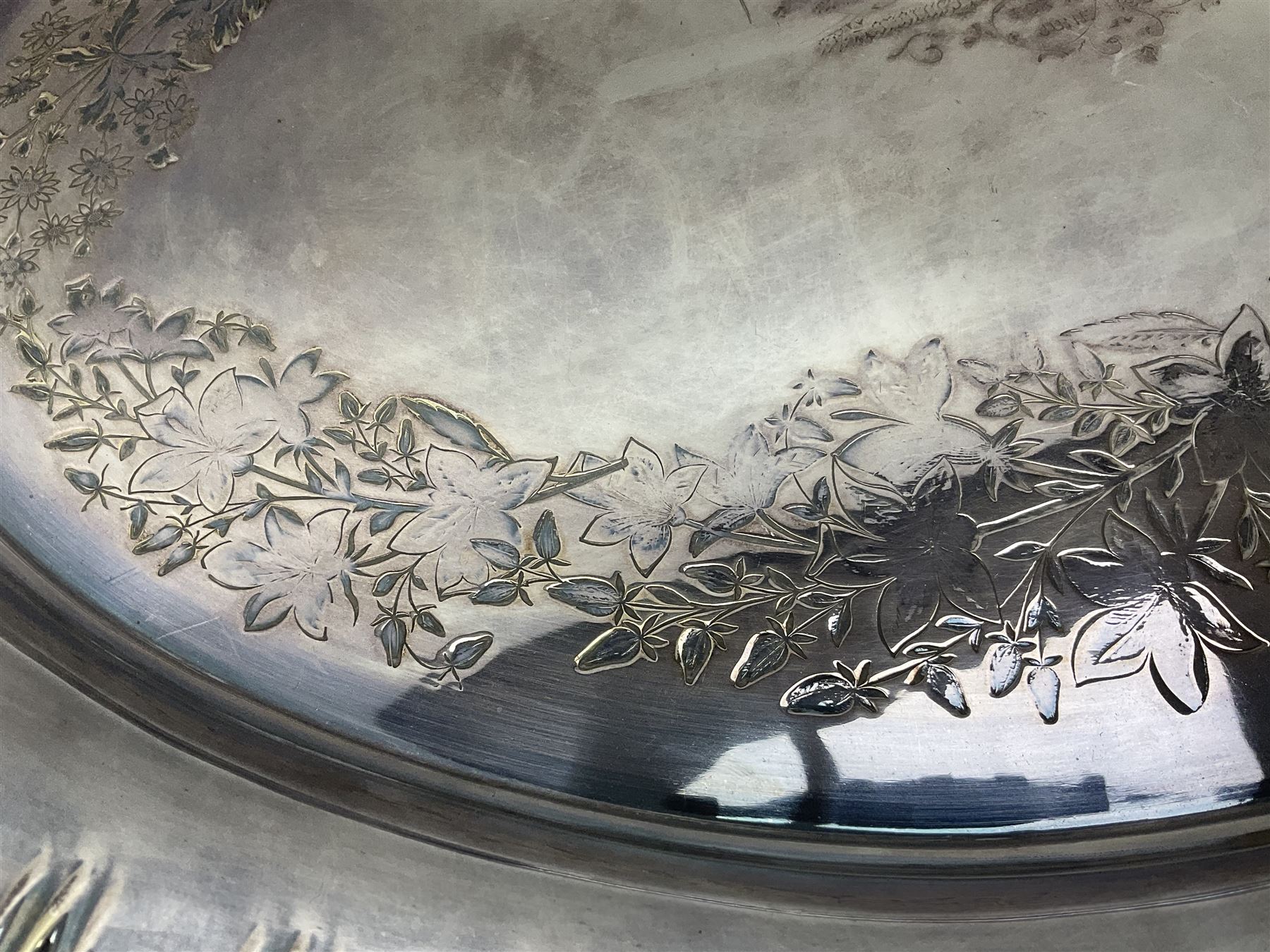 Oval silver plate twin handled tray, egg and dart edge, engraved with floral springs surrounding an central inscription, L65cm
