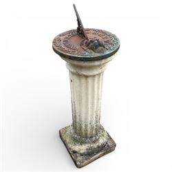 Cast stone garden sundial featuring a cast iron top with Roman numerals and lions head motif