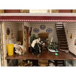 Seagull Pub - scratch-built wooden doll's house as a two-storey gable fronted public house painted in white green and maroon; the hinged front with ground floor veranda and window over opening to reveal two fully furnished rooms with dog-leg staircase and well stocked bar with bar-tender L31cm H62cm D37cm; together with Corner Shop and Dollies Pantry; a similarly painted scratch-built wooden two-storey flat-roofed doll's house as a well stocked ground floor grocery shop with stairs up to two further fully furnished rooms and more stairs giving access to a roof terrace L46cm H57cm D33cm (2)
