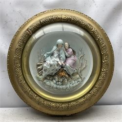 Set of four early 20th century Continental bisque plaques, each of circular form, modelled in high relief as the Four Seasons personified, within gilded circular frames under convex glass, overall D44.5cm