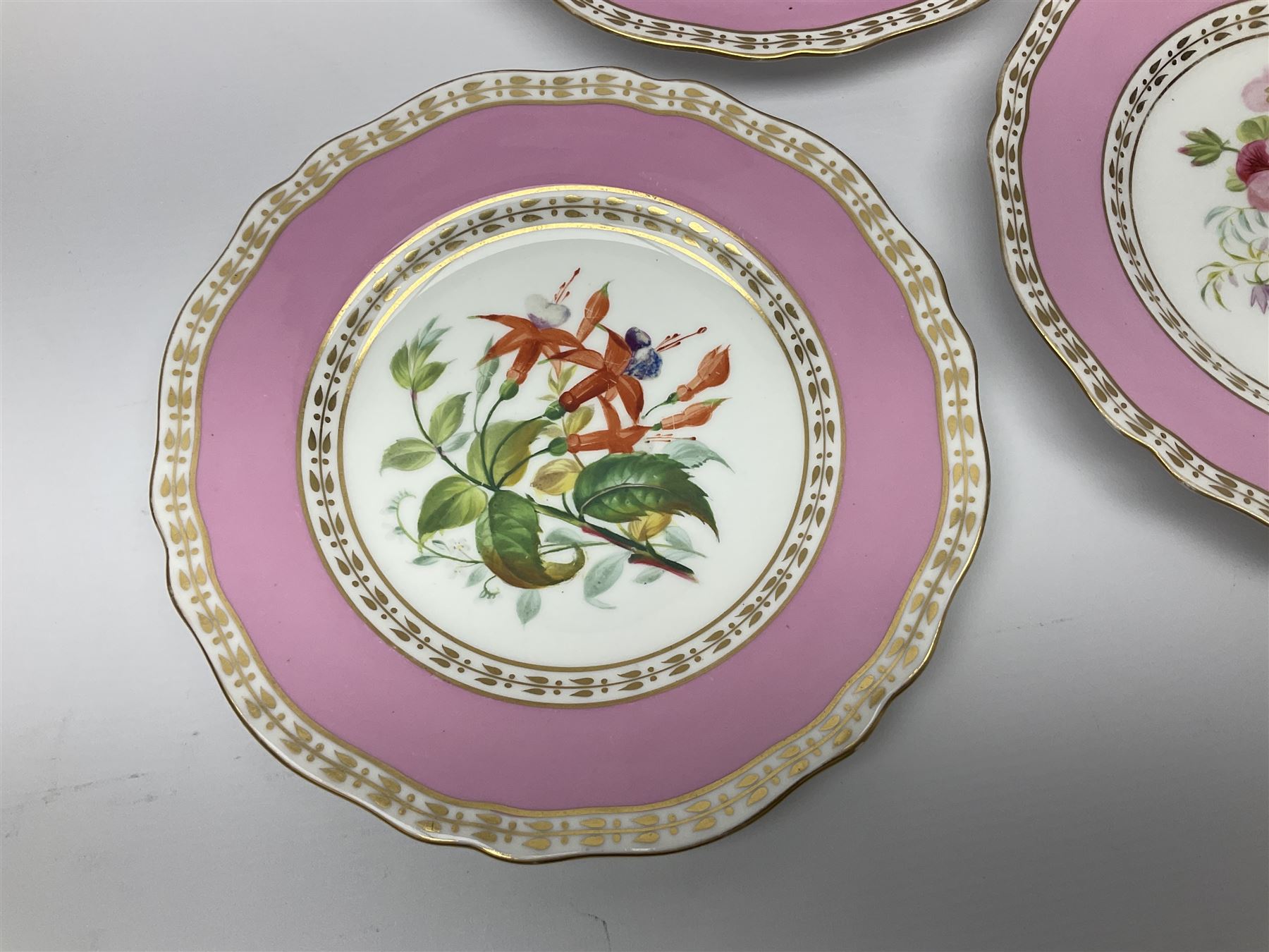 Victorian Copeland, Botanical dessert service, decorated with floral sprigs to the centre with a pink and gilt border, comprising five comports and seven plates, largest comport H20cm, plate D22cm