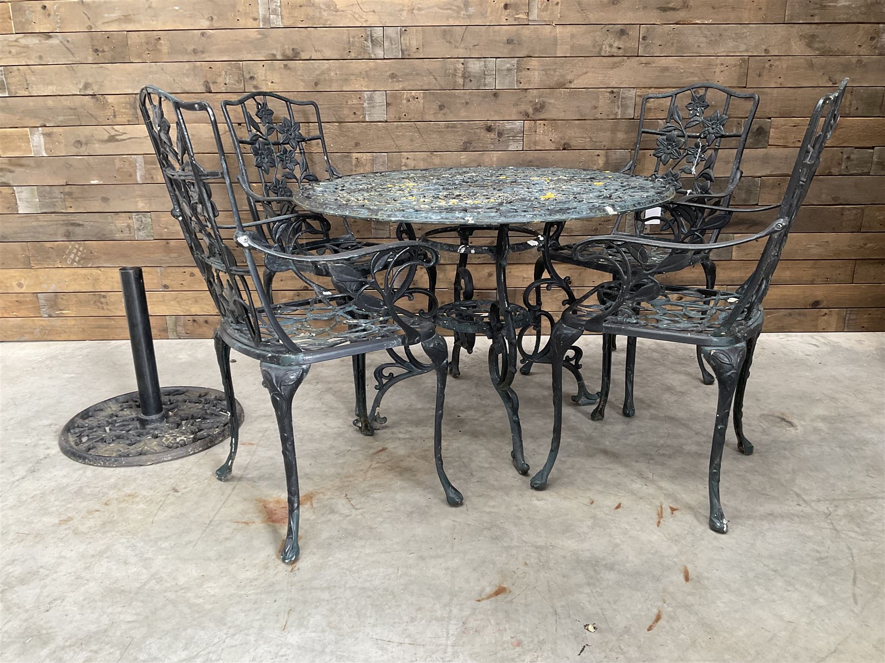 Victorian design painted aluminium circular garden table and four chairs, with parasol base