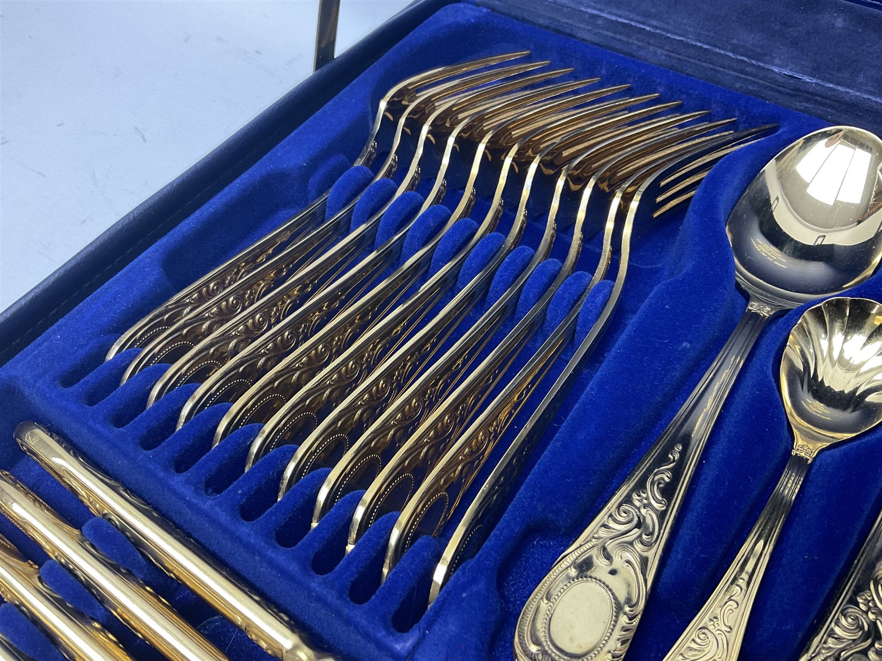 Bestecke Solingen canteen of gold plated cutlery for twelve place settings, including ladle, cake slice, fish servers, fish knives and forks, 108 pieces total, contained within a briefcase 