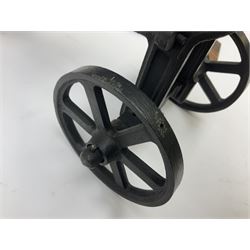 Black painted heavy cast metal model of a cannon on field carriage L41.5cm; loose mounted on oak base