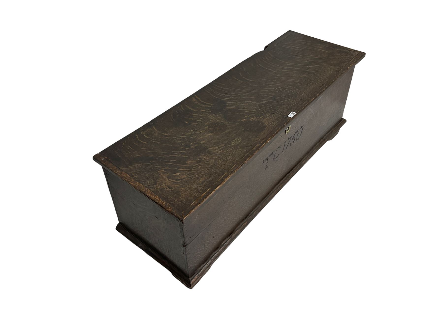 18th century oak sword chest or coffer, hinged lid with moulded edge and iron fittings concealing candle box and main compartment, the front with studwork spelling 'TC 1750', raised on bracket feet
