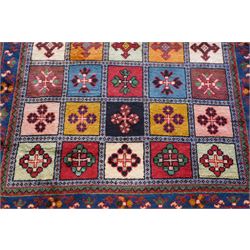 Persian Gabbeh indigo ground runner rug of garden design, the multi-coloured field decorated with five columns of panels in contrasting colours with stylised plant motifs, the guard band with trailing foliage