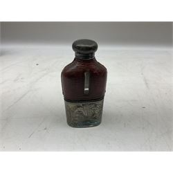 Cast metal nutcracker, in the form of a dog together with a pair of Swift Saratoga 8x40 binoculars in leather case and a hip flask, the glass flask covered in leather to the top with a detachable silver plated cup to base