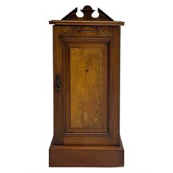 Victorian walnut bedroom suite - wardrobe, dressing chest and bedside cupboard, comprising a full-length wardrobe with broken pediment and central mirrored door, large lower drawer, a matching dressing table with bevelled swing mirror over two trinket drawers and two short drawers over two long drawers, and a single-door bedside cupboard, all with moulded edges, decorative panel work and shaped aprons