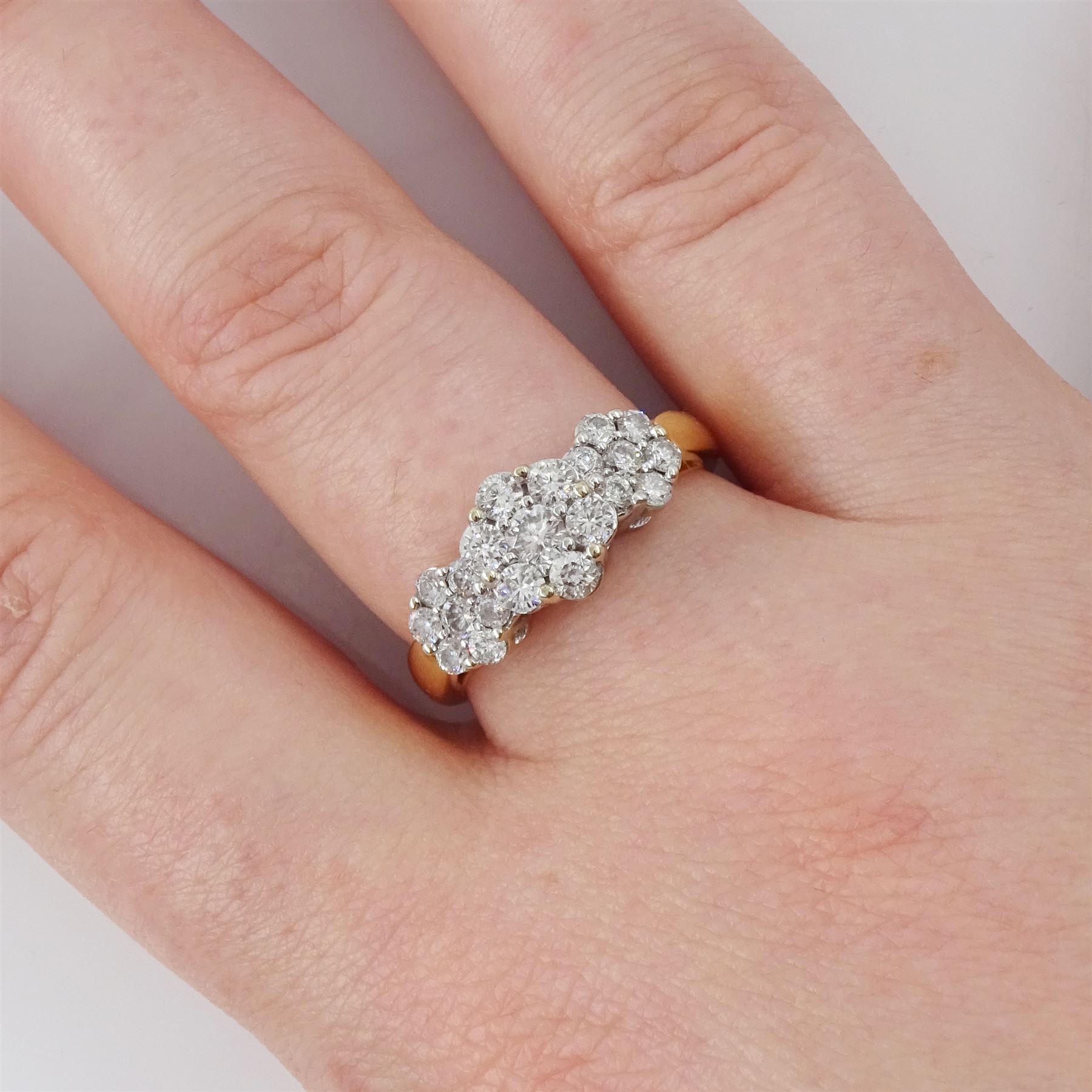 18ct gold diamond flower head cluster ring, three clusters each set with seven round brilliant cut diamonds, total diamond weight approx 0.90 carat
