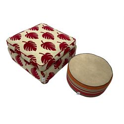 Square footstool upholstered in cream and red leaf patterned fabric (W82cm H35cm); and circular pouffe upholstered in striped multi-colour fabric (W64cm H30cm)