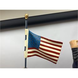 Composite Superman with cape, together with a composite female statue holding the American flag, tallest example H103cm