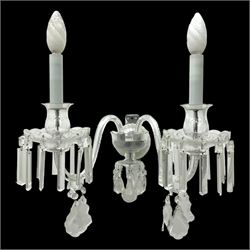 Pair of cut glass two branch wall sconce candelabras, each with S scroll extending branches with shaped and bevelled circular drip trays, hung with pendant drops