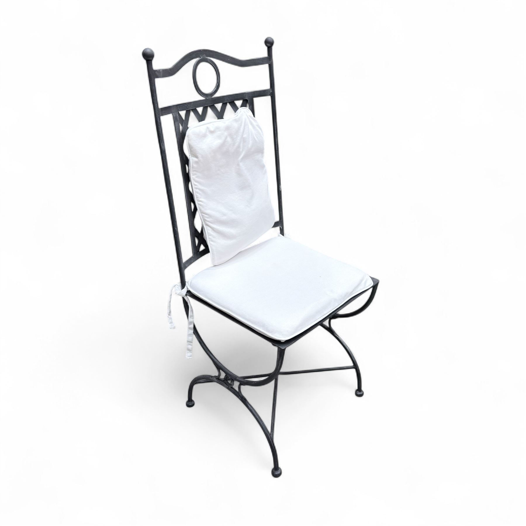 Wrought steel rectangular conservatory dining table, with glass top; and six, four side and two armchairs, with lattice backs and X framed bases, loose cushions