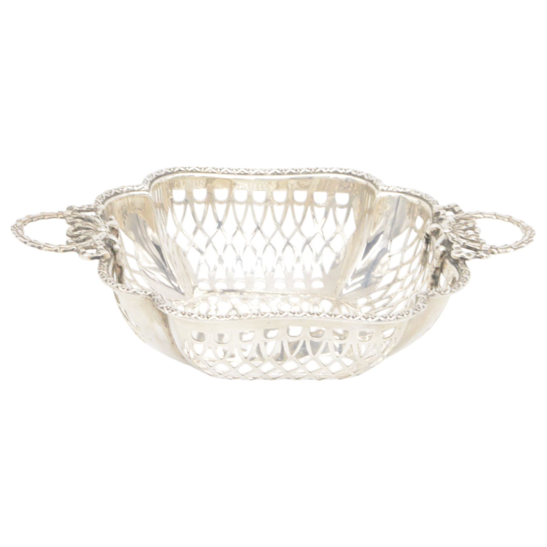 Three mid 20th century silver bowls, including two circular examples with pierced sides and a square example with twin handles, all hallmarked