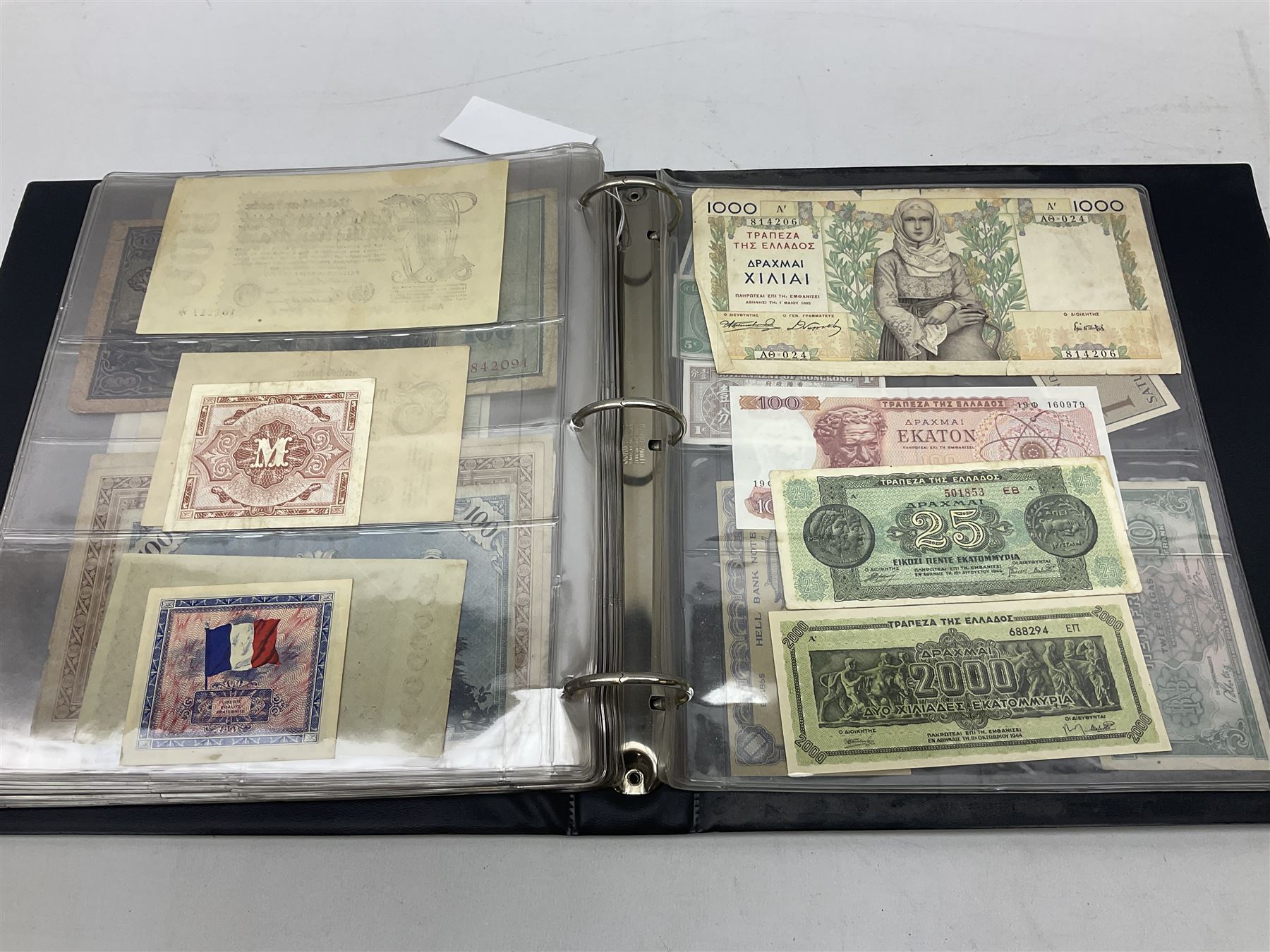 World banknotes, including Queen Elizabeth II The States of Jersey one pound 'DB202703', five pounds 'BB527762' and ten pounds 'AB651481', reserve bank of New Zealand two dollars '1L3 741894', King George V Straits Settlements one dollar 1st January 1935 'F/83 28924', various Bank of England notes etc, housed in two ring binder albums