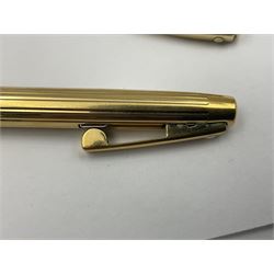 Sheaffer Triumph Imperial fountain pen, the gold plated barrel with fluted stripe design and gold nib stamped 14K 585, together with a Sheaffer Targa slimline fountain pen with gold plated barrel similarly decorated with gold nib stamped 14K 585, ballpoint pen and propelling pencil, each with a fluted gold plated barrel, largest L13.5cm (4)