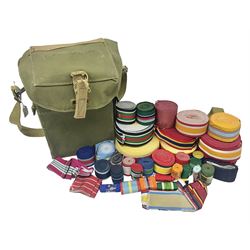 Quantity of modern medal ribbons in various length rolls and strips; and WW2 gas mask case dated 1943