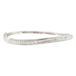 18ct white gold channel set round brilliant cut and baguette cut diamond twist bangle, Sheffield 2002, total diamond weight approx 1.00 carat