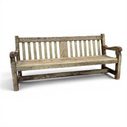 Teak garden bench with slatted back and seat raised on square supports