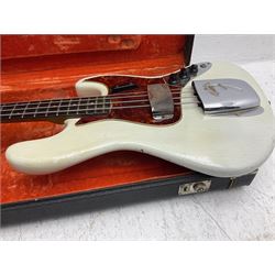 1963 Fender Jazz three-knob bass guitar; impressed with date code 7AUG63A on end of neck and serial no.L08587 on back plate; all original but re-finished in white in the 1970s; sold with photographs of the instrument in the 1960s with original finish and in the 1970s re-finished; L117.5cm; in original hard carrying case; Provenance: the professional guitar of Howard Livett from new to his death in 2005. Howard played in The Humperdincks, the backing group for Englebert Humperdinck, also played in the backing group for Max Bygraves and in the band Hedgehoppers Anonymous. The guitar is also sold with a manuscript letter of provenance from Howard's wife.