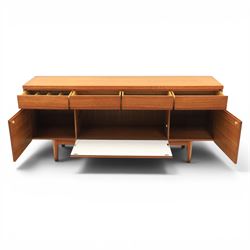 Mid-20th century teak sideboard, rectangular top above four frieze drawers with recessed handles, flanked by two cupboard doors with fall front central media cupboard