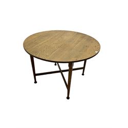 Early 20th century Arts and Crafts period oak table, circular top raised on tapered supports with pad feet, united by X-stretcher