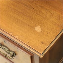 Edwardian figured walnut dressing chest, with central tilting mirror with pierced fret work, flanked by cabinet with figured walnut panelled door above a trinket drawer, with four short over a long long drawer, raised on a plinth base with castors 