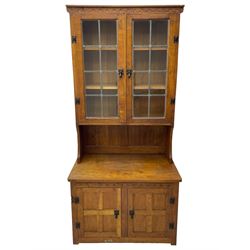 Gnomeman - adzed oak dresser, arcade carved cresting rail over two lead glazed doors, double cupboard below enclosed by two panelled doors, carved with gnome signature, by Thomas Whittaker, Little Beck 