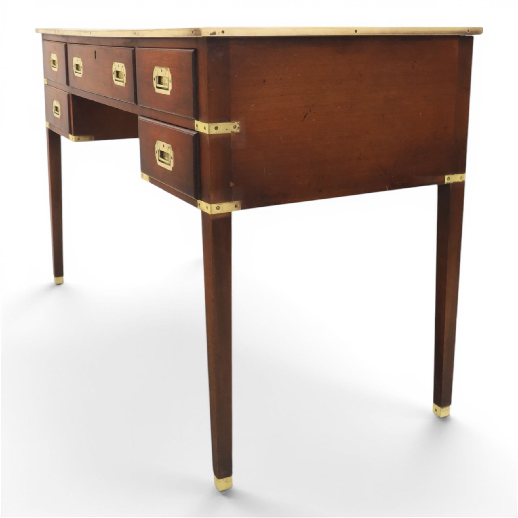 Military campaign style mahogany writing desk, inset gilt-tooled green leather writing surface, fitted with five drawers with recessed brass handles, brass corner mounts and protective bindings, on square tapering legs