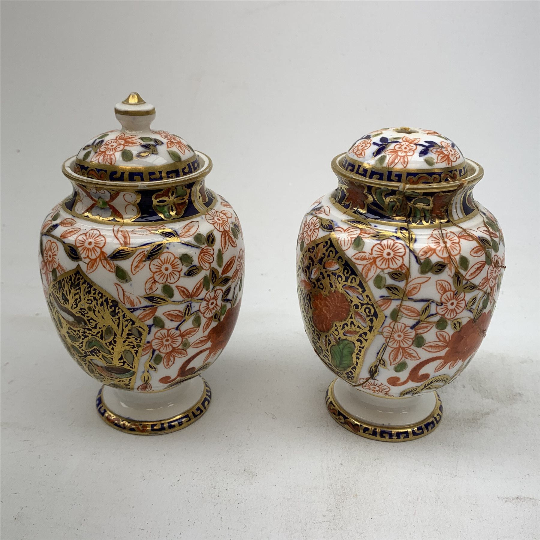 Three Bloor Derby Imari pattern twin handle urms, two examples with covers, each with mark beneath, H12cm, (all a/f), together with a pair of late 19th century Royal Crown Derby Imari pattern urns and covers, each with mark beneath, H13cm, (one significantly a/f). 