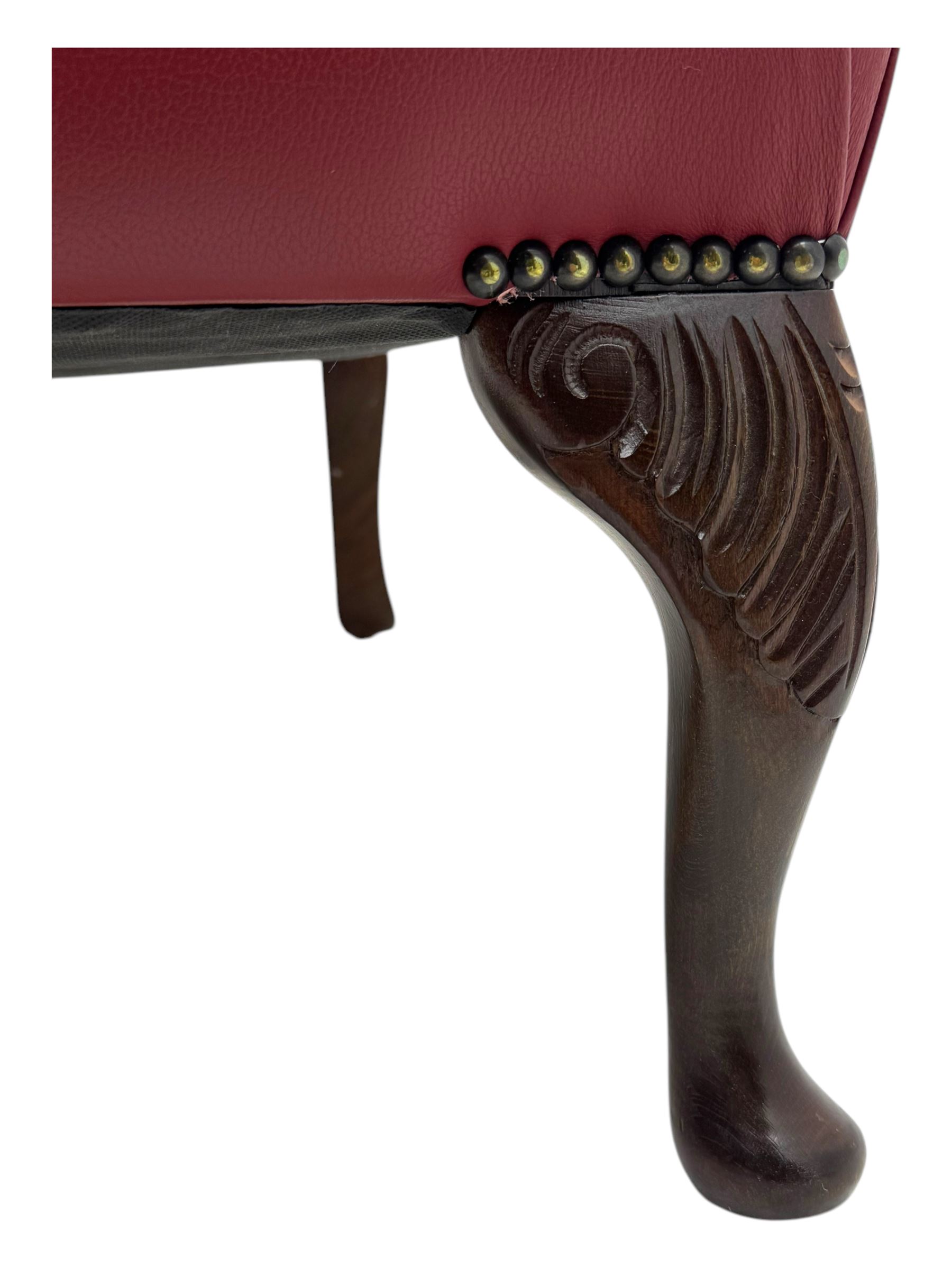 Kingsgate - contemporary 'Queen Anne' wingback armchair with matching stool, high back with deep button tufting, upholstered in red leather with brass stud trim, on carved cabriole supports