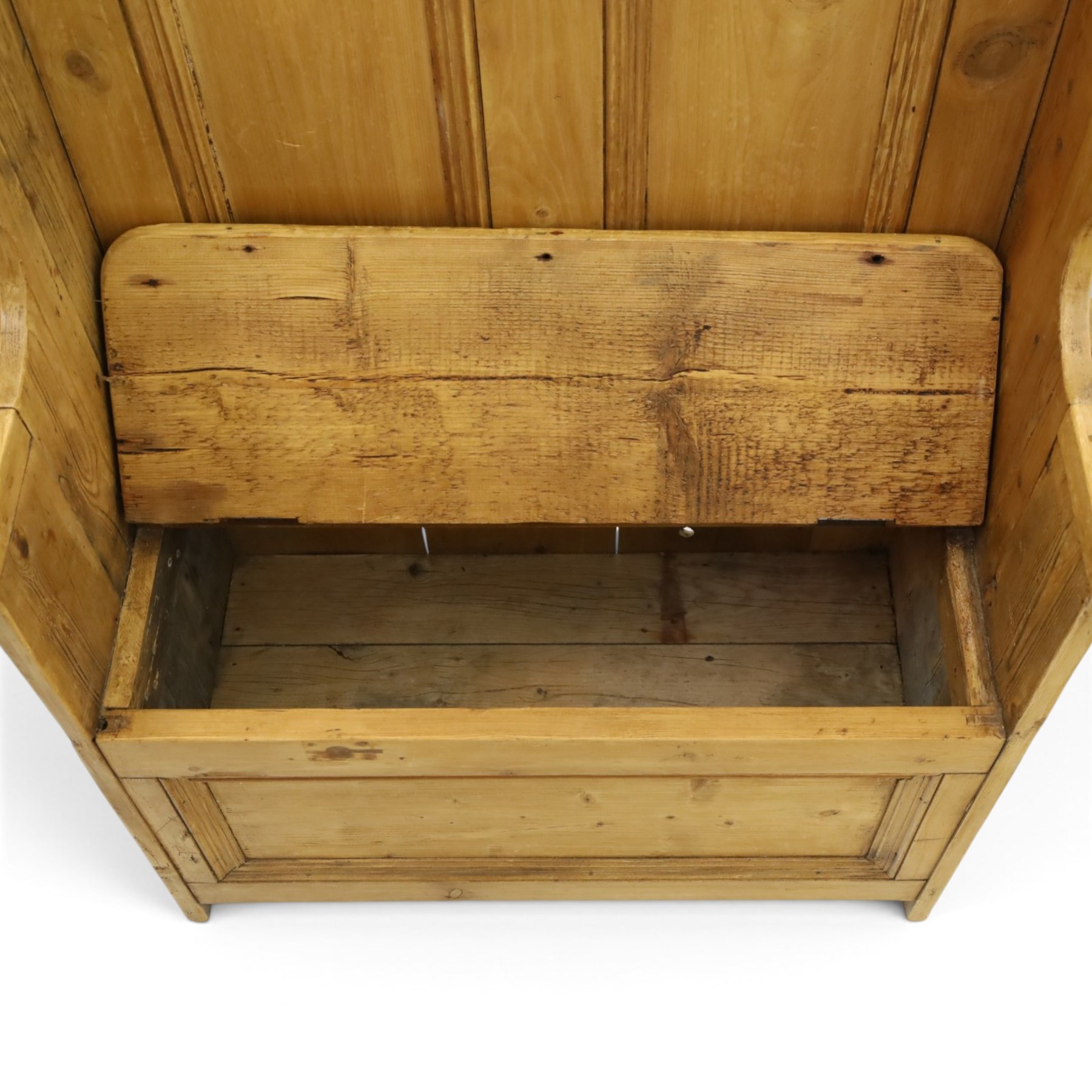 Victorian waxed pine settle or hall bench, shaped cresting rail over double panelled back, outswept arms on hinged box-seat, on end supports