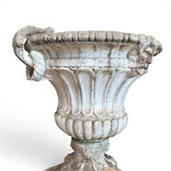 Pair of Neoclassical design cast stone garden urns, each of campana form with fluted body and gadrooned underbelly, decorated with faun/satyr opposing masks and ropetwist handles, with floral and mask design to the socles, raised on square bases, finished in weathered white patina