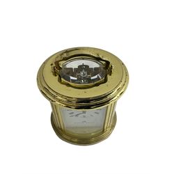 English - 20th century  8-day oval carriage clock, in a polished gilt case with an enamel dial, Roman numerals and moon hands, dial inscribed Mathew Norman, London, timepiece spring driven movement with a lever platform escapement, balance with timing screws. 