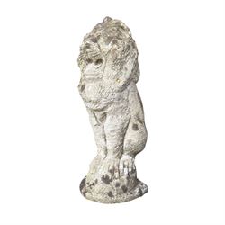 Four weathered cast stone lions in seated poses