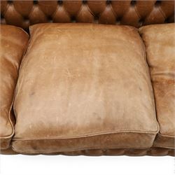 Fleming & Howland Ltd - large traditional shape four seater chesterfield club sofa, the rolled ack and arms with studwork, upholstered in buttoned tan leather with loose seat cushions, raised on large turned feet