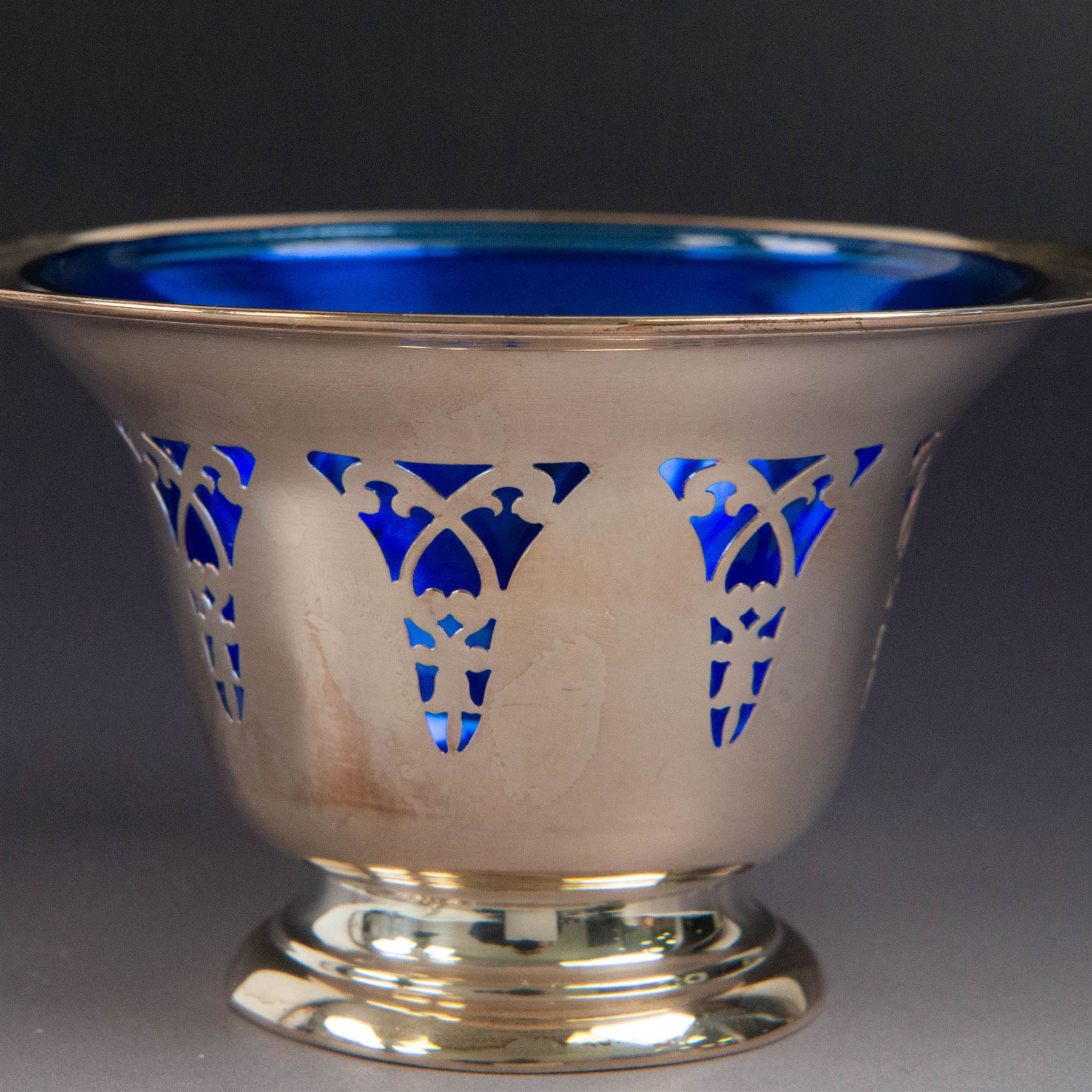 American silver sugar bowl, of circular form with fluted rim and fluted sides, upon stepped circular foot, stamped Sterling by Roden, with blue glass liner