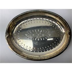 Silver plated warming entree dish of oval form with revolving engraved cover, the interior fitted with pierced lift out tray housed above another lift out tray, raised on four tapering legs with foliate decoration