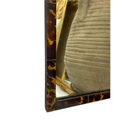 Early 20th century wall hanging tortoise shell framed mirror, of rectangular form, the upper half of the frame shaped and stepped surrounding a plain mirror plate