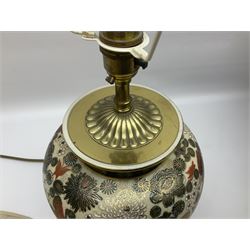 Pair of Japanese ceramic table lamps, decorated with flowers and butterflies upon a circular wooden base, with shades H52cm