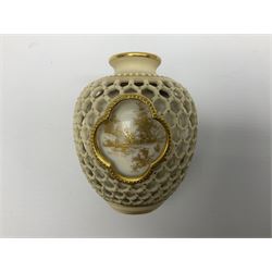 Late 19th century Royal Worcester reticulated double walled vase by George Owen, of ovoid form the openwork outer wall with honeycomb piercing around three quatrefoil panels framing gilt pained landscapes to the inner wall, with puce printed mark beneath, H8.5cm