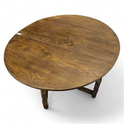 17th century design oak gateleg dining table, oval drop-leaf top on baluster turned supports, twin swinging gate legs united by peripheral stretchers (Extends to 149cm)