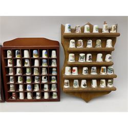 Quantity of thimbles to include ceramic and metal and cloisonné examples, housed in four wood display cases, together with a quantity of loose and boxed examples