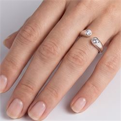 Platinum two stone diamond ring, the two bezel set finials set with a round brilliant cut diamond, Sheffield 1996, total diamond weight approx 0.40 carat