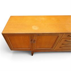 G-Plan - 'Fresco Long John' teak mid 20th century sideboard, a central bank of four drawers, flanked by twin cupboard doors, with recessed handles, on a tapering supports 