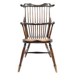 Unusual 19th century elm and beech high comb back Windsor armchair, the serpentine cresting rail carved with serpent heads over stick back, the arms with serpent head carved terminals, dished seat, turned supports joined by H stretcher