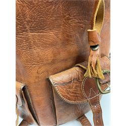 Mid-20th century plush covered teddy bear the revolving head with applied eyes, vertically stitched nose and jointed limbs with rexine pads H58cm; together with a leather backpack (2)