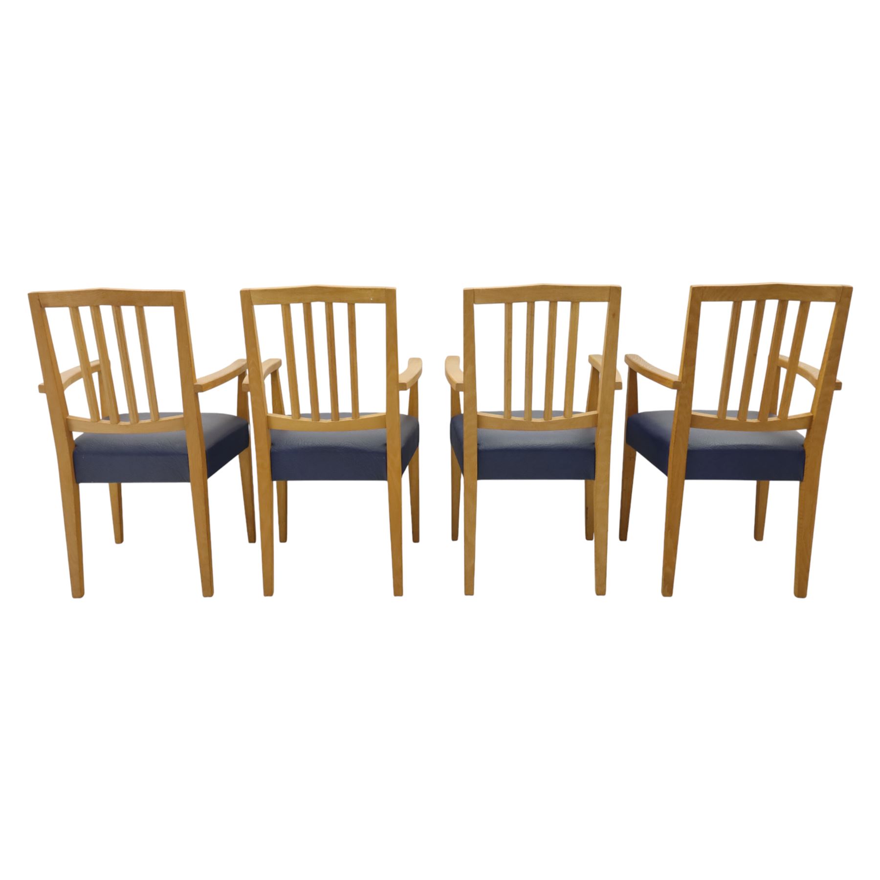 Modern twelve oak dining chairs including one 'Chairmans' chair, solid oak construction, slatted back and arm rests, blue leatherette padded seat, on tapered square supports 