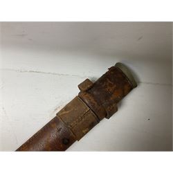 George V 1897 pattern Infantry officers sword, the 82cm single fullered blade with traces of etched detail and George V crown cipher, the ricasso marked Hawksworth Sheffield, pierced half basket hilt with George V cypher, wire-bound fish-skin grip with brass pommel and backstrap; in leather scabbard L102cm overall; together with two sectional gun cleaning rods; swagger stick made of leather strips etc